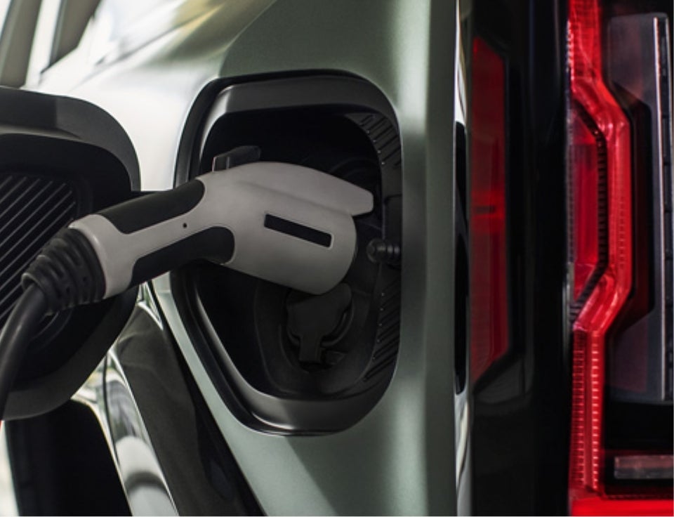 Close up of charging port with charger plugged in on a GMC Hummer EV SUV - Bonander GMC in TURLOCK CA